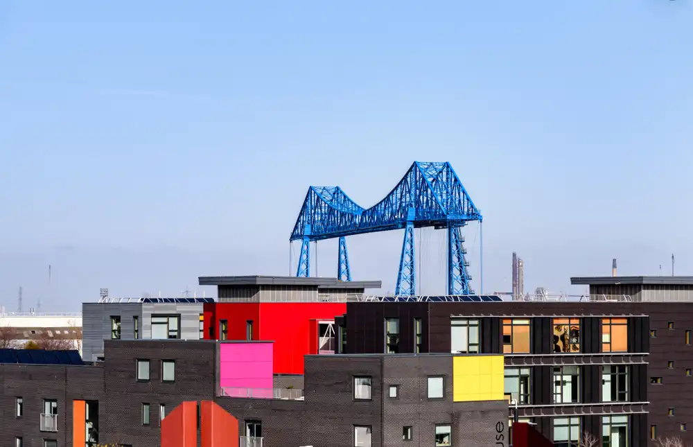 The blue Transporter Bridge above colourful buildings in Middlesbrough, UK The blue Transporter Bridge above colourful buildings in Middlesbrough, UK